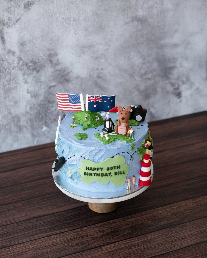 A world themed cake featuring countries and the sea with edible decorations of the person's life.