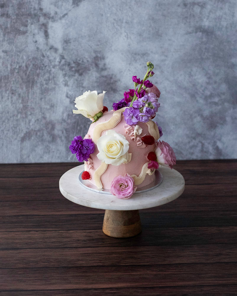 A dome wedding cake with flowers
