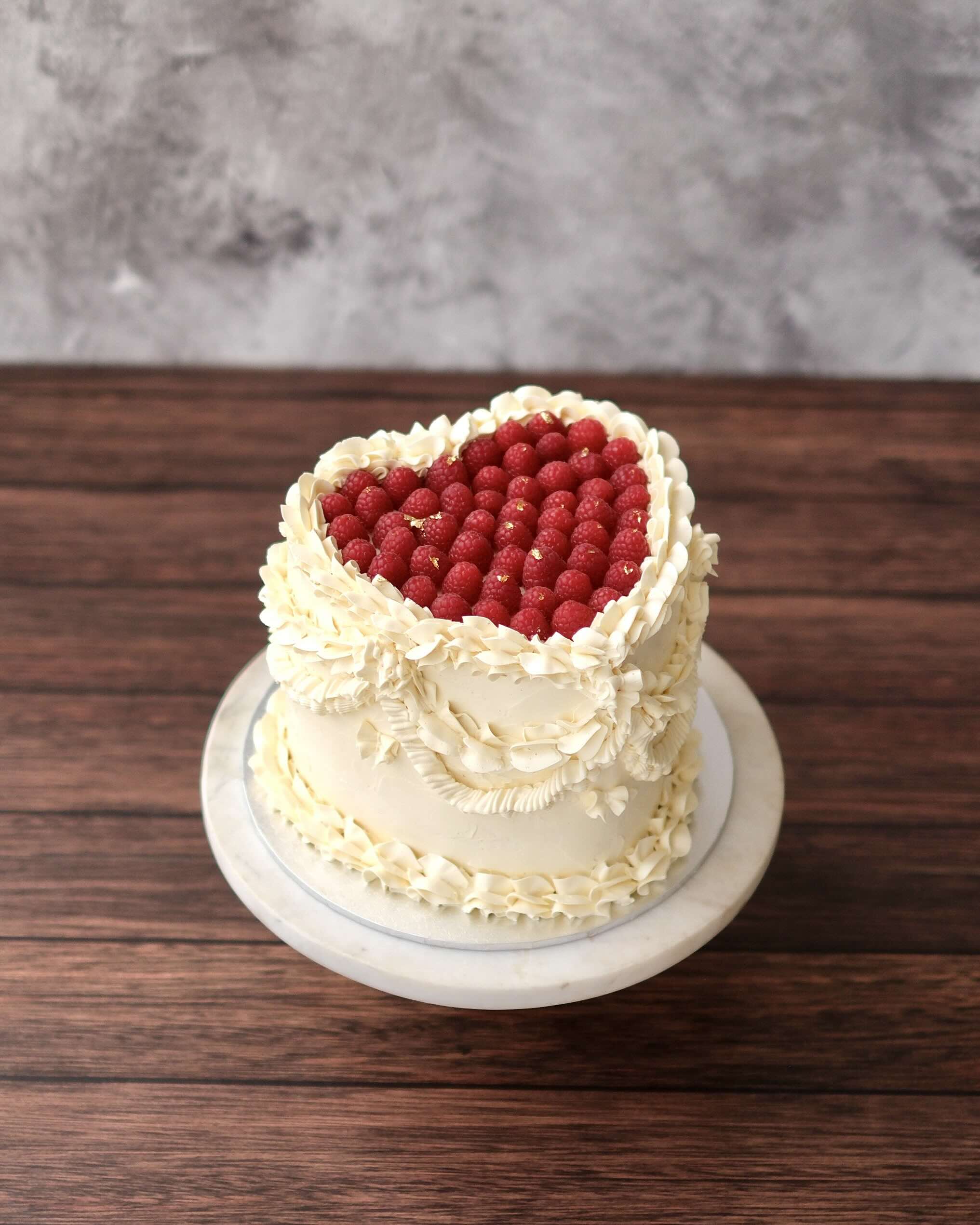 a heart-shaped raspberry design with vintage piped buttercream dairy free gluten free optional.