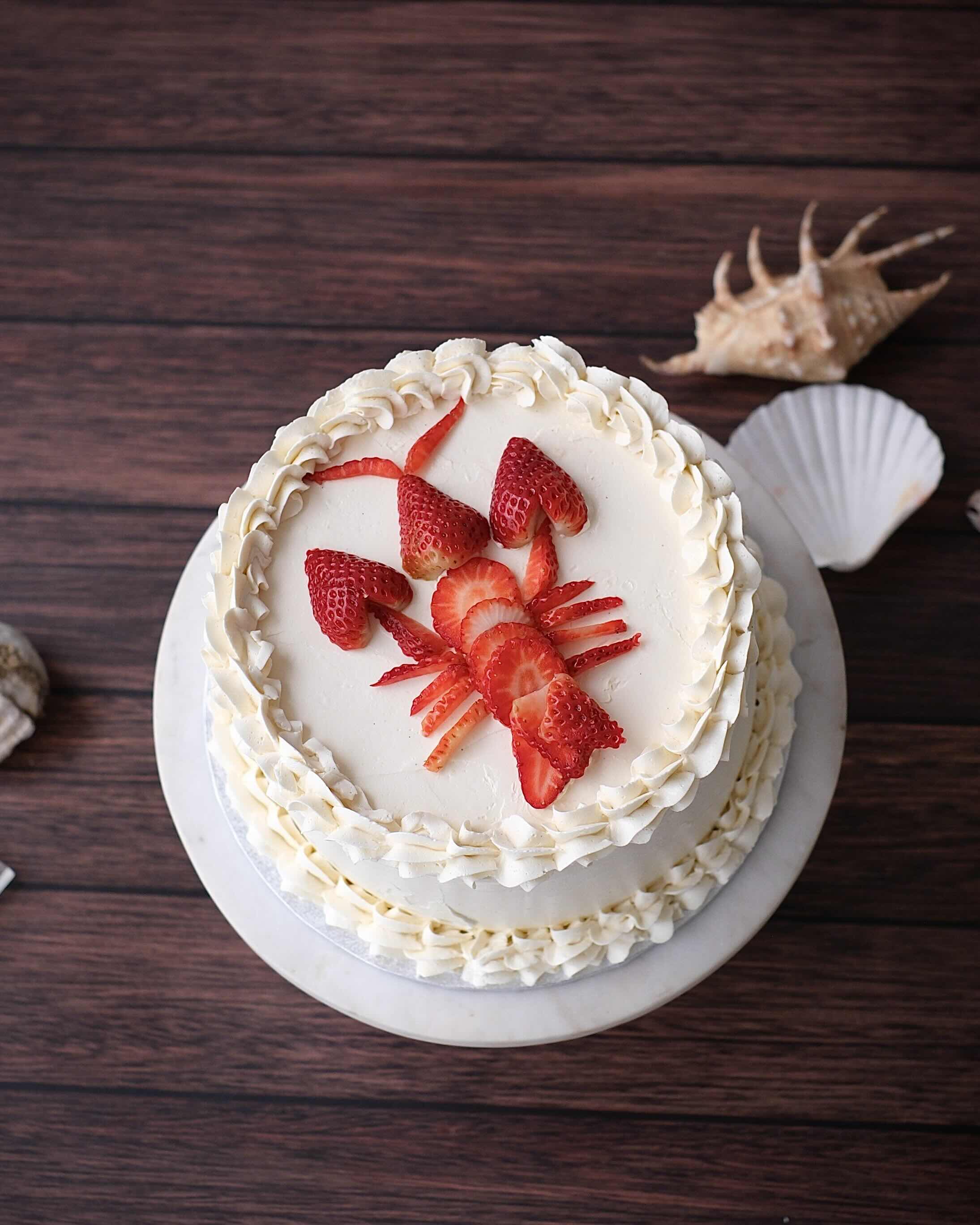 A custom strawberry celebration cake with smooth buttercream and fresh strawberries, handcrafted in Perth.